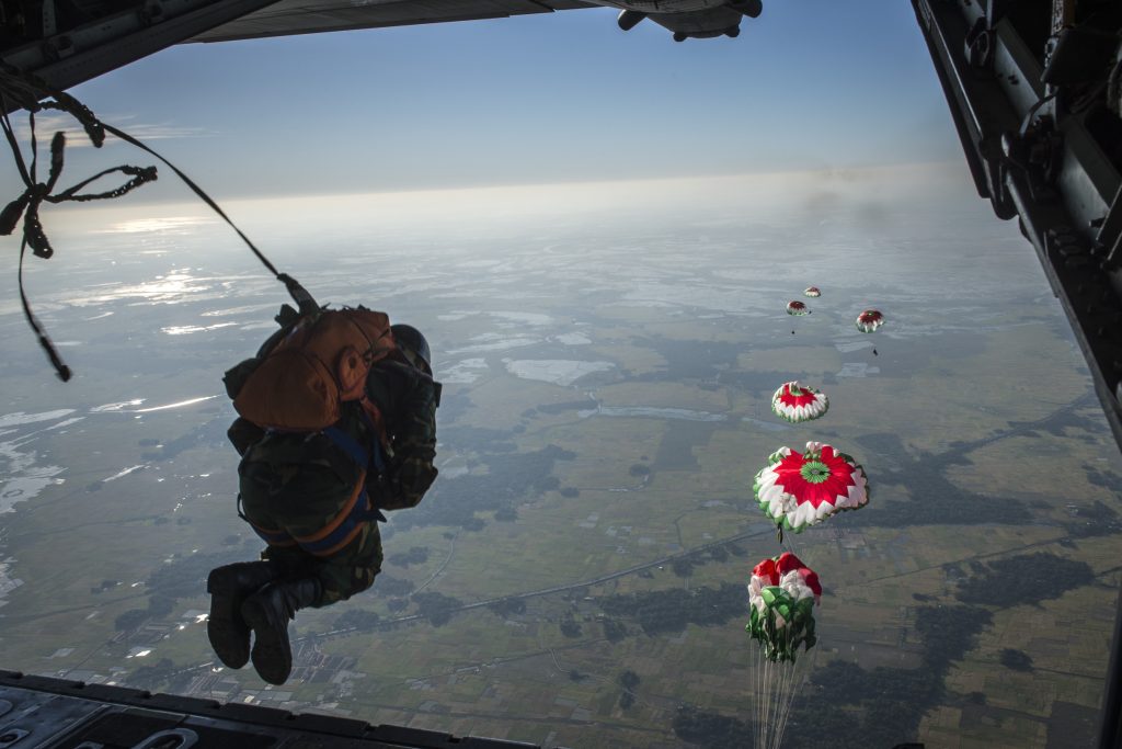 Bangladesh Air Force paratroopers descend from a C-130 aircraft